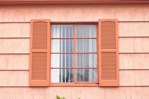 Vintage window with orange tone wall