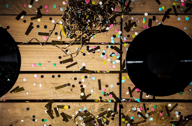 Vinyl records between colourful confetti