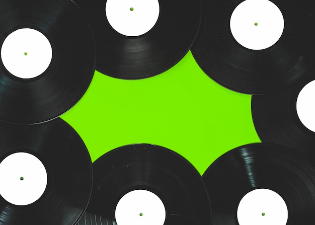 Vinyl records on green background
