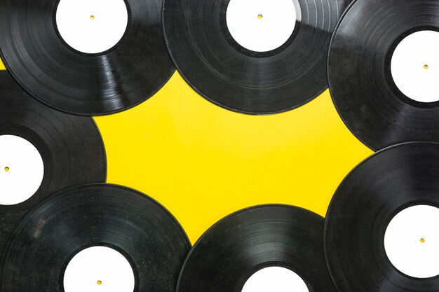 Vinyl records on yellow background