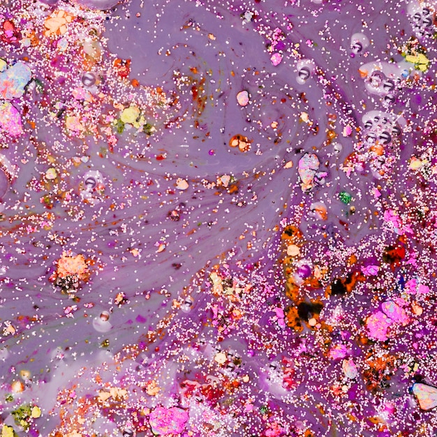 Violet liquid with colourful crumbs