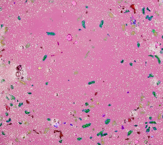 Violet liquid with different colourful crumbs