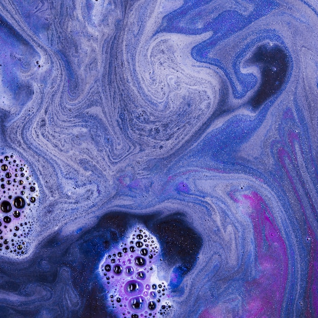 Violet liquid with light pink foam