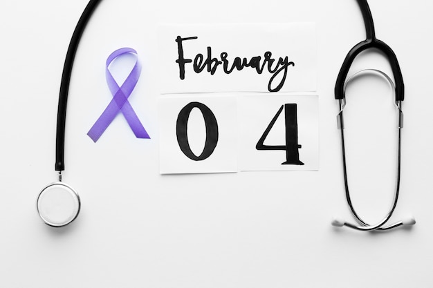 Free photo violet ribbon near stethoscope and date