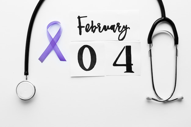Violet ribbon near stethoscope and date