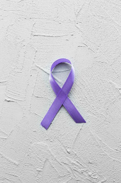 Violet ribbon on plaster background