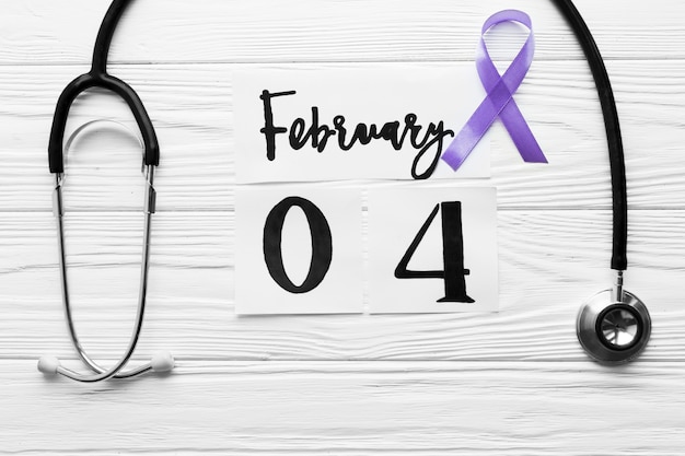 Free photo violet ribbon between stethoscope and date