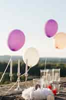 Free photo violet and white balloons soar over the candles