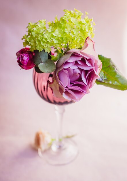Violet wineglass with hydrangea and rose