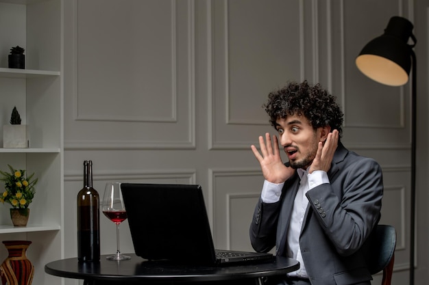 Virtual love handsome cute guy in suit with wine on a distance computer date shocked waving hands