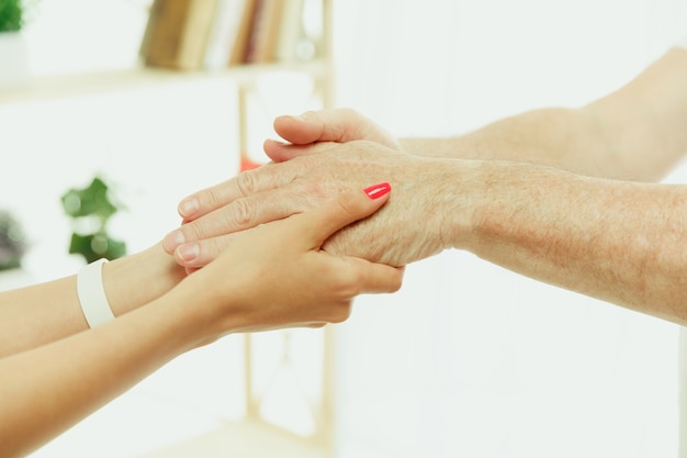 The visiting nurse or health visitor taking care of senior man