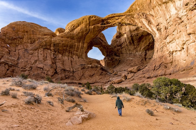 A visitor approaching the Double Arch