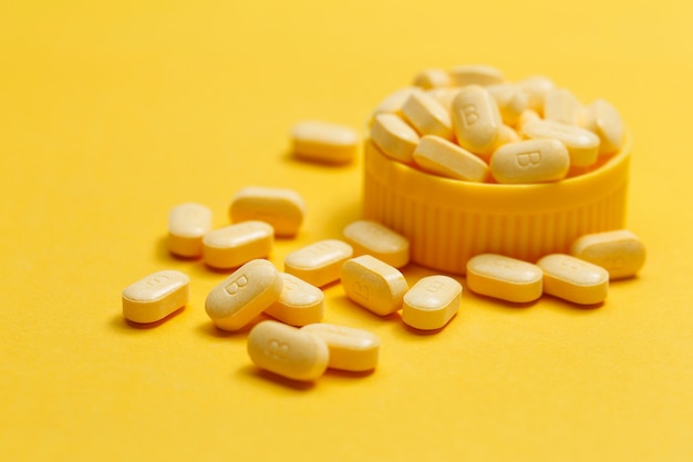 Vitamin B Tablets On Yellow Background