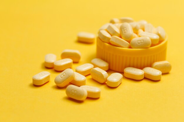 vitamin B tablets on yellow background