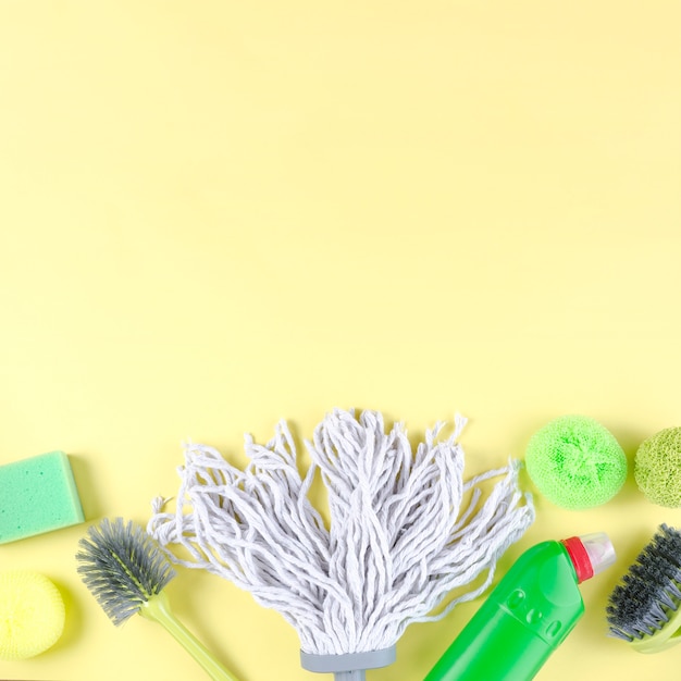 Vivid cleaning items on yellow background