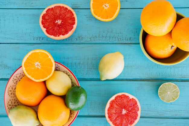 Vivid fresh citrus fruits on wooden surface