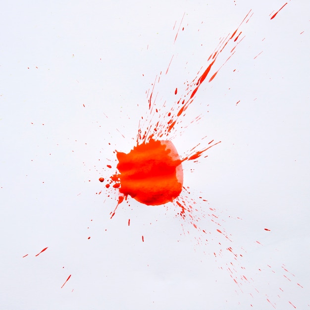 Vivid red paint stain on white