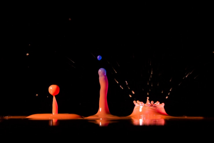 Free Photo vivid splashes of drops on black