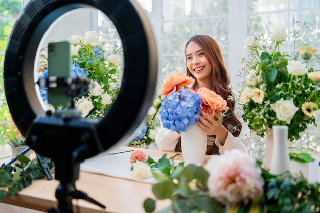 Free photo vlog streaming broadcast flower floral arrangement online course asian florist suggest and teaching how to make perfect bouqet flower vase online workshop creative hobby web class floristry decor