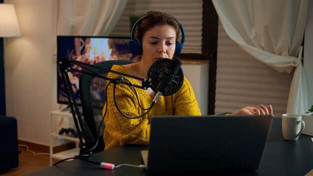 Vlogger on air during online show using laptop, reading emails. Creative online show On-air production internet broadcast host streaming live content, recording digital social media communication