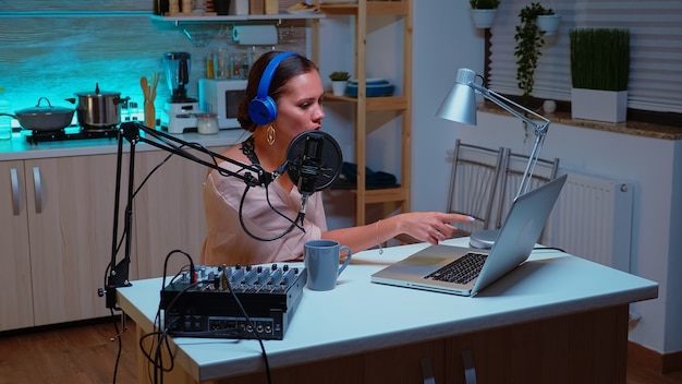 Vlogger messaging her online audience while recording podcast in home studio for social media. Creative online show On-air production internet broadcast host streaming live content, recording digital