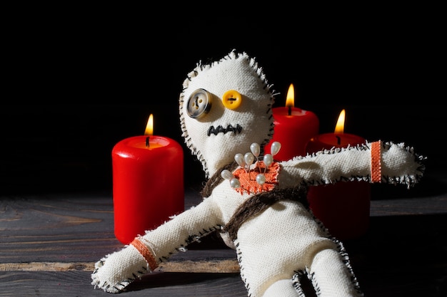 Free photo vodoo doll and candles high angle