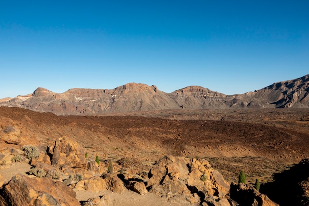 Free photo volcanic red soil crater with clear sky