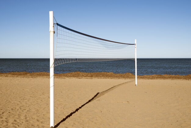 Volleyball net in the sandy beach during the daytime