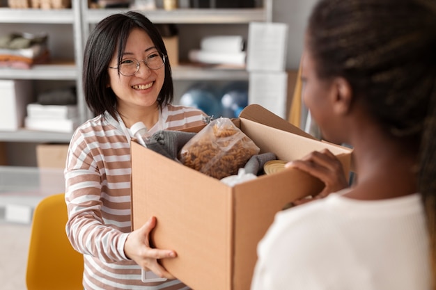 Volunteer handing a donation box