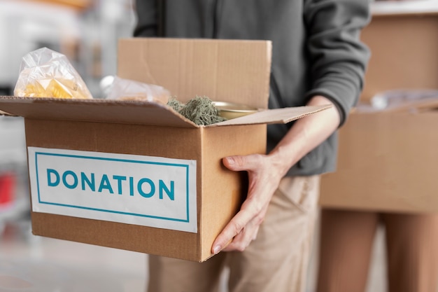 Volunteer handling a donation box