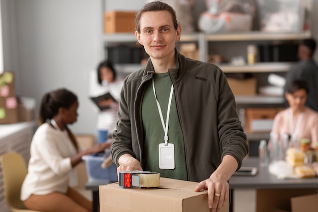 Volunteer helping with donation box