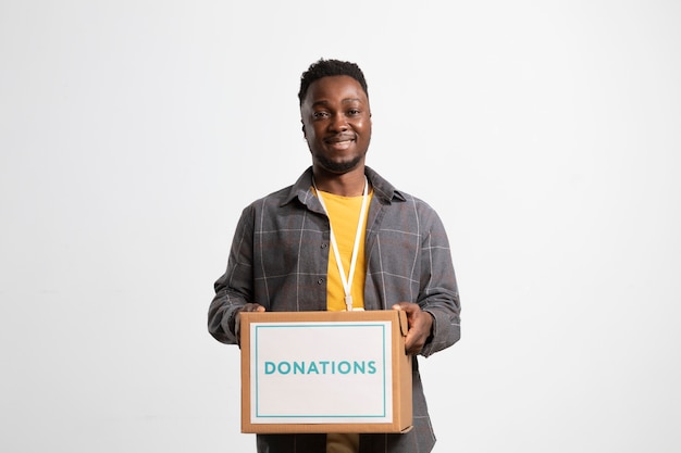 Volunteer holding a box containing donations for charity