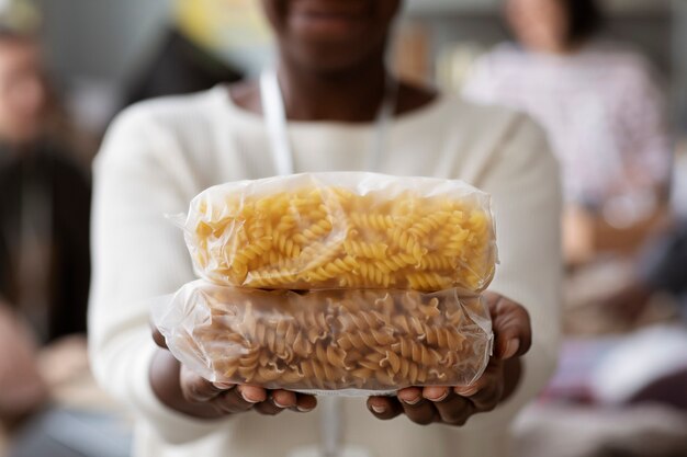 Volunteer holding food donations collected for charity