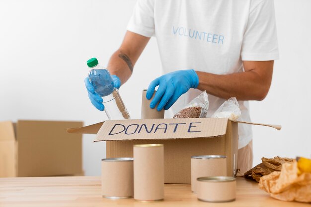 Volunteer placing different goodies in donation boxes