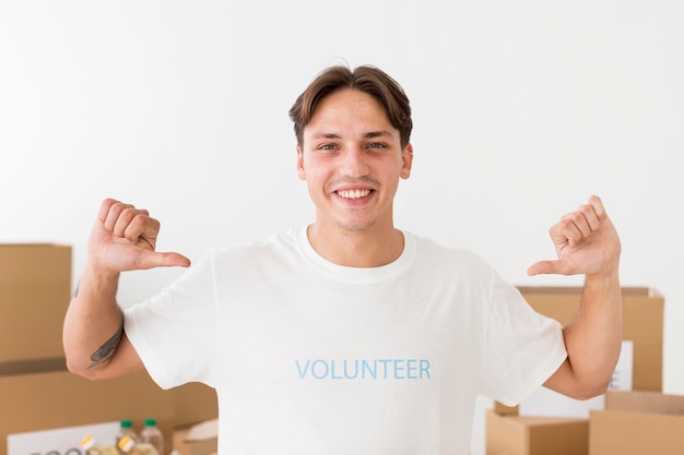 Volunteer pointing to his t-shirt