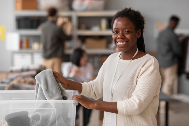 Volunteer selecting and organizing clothes donations for charity