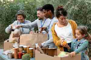 Free photo volunteers collecting food donations medium shot