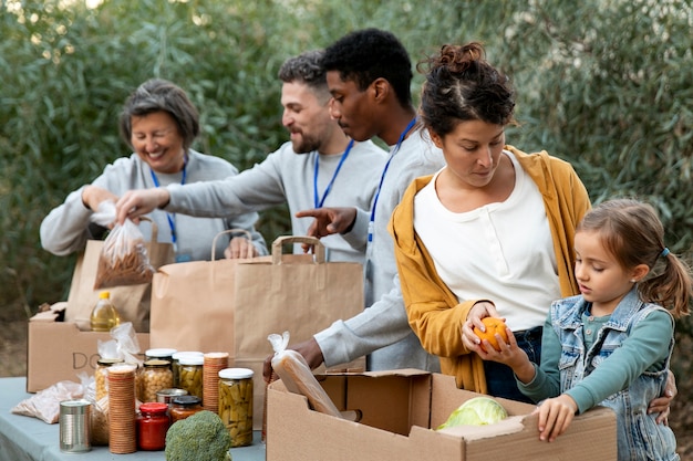 Volunteers collecting food donations medium shot