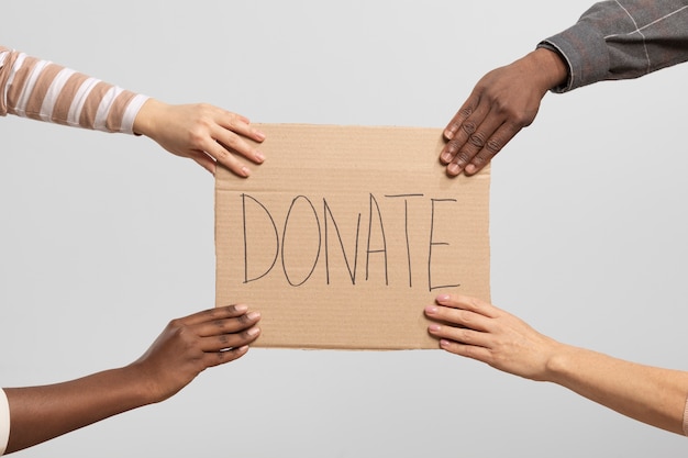 Volunteers holding a box containing donations for charity