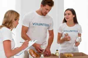 Free photo volunteers preparing boxes with food donations