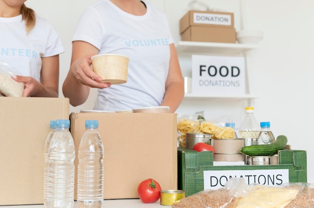 Volunteers putting food for donation in box