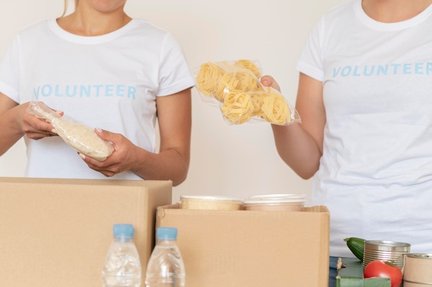 Volunteers putting provisions for donation in box