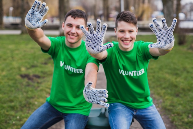 Free photo volunteers showing gloves