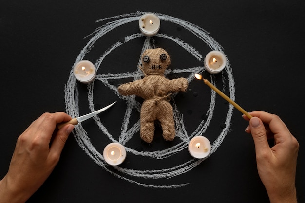 Free photo voodoo doll and candles flat lay