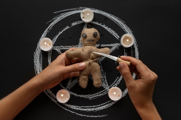 Free photo voodoo doll and candles above view