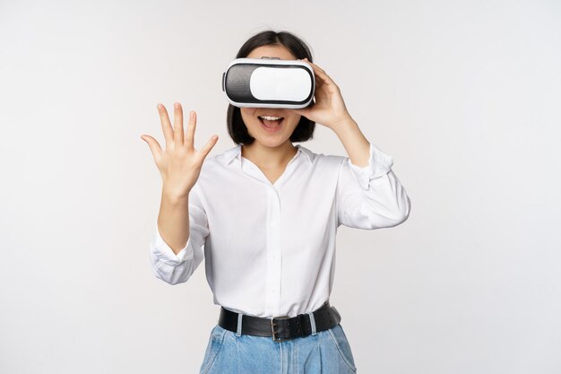 Vr chat Asian girl saying hello in virtual reality glasses smiling enthusiastic concept of communication and future technology white background