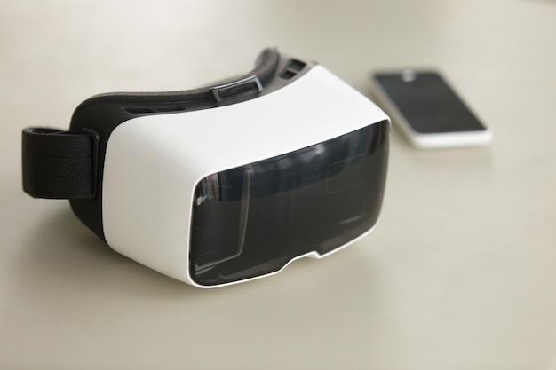 VR headset and smartphone on desk, virtual reality mobile technology