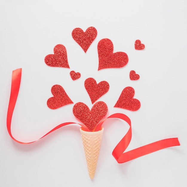 Free photo wafer cup with ornament hearts and ribbon