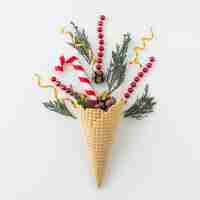 Free photo waffle cone with branches and candy cane