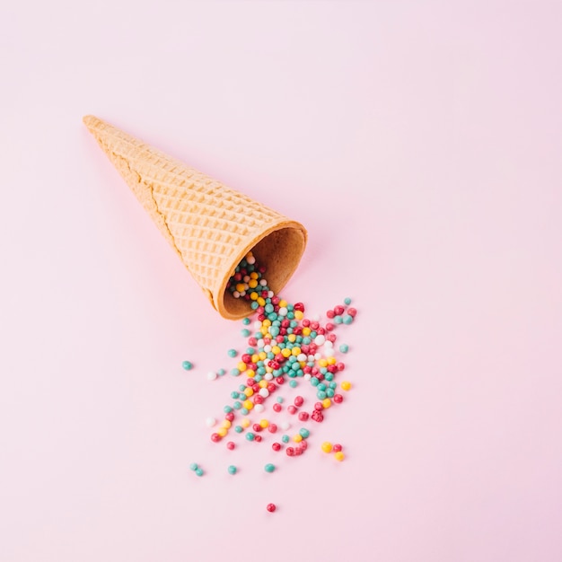 Free photo waffle cone with colorful sprinkles